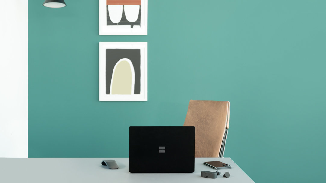 Surface laptop 5 in office with a blue wall