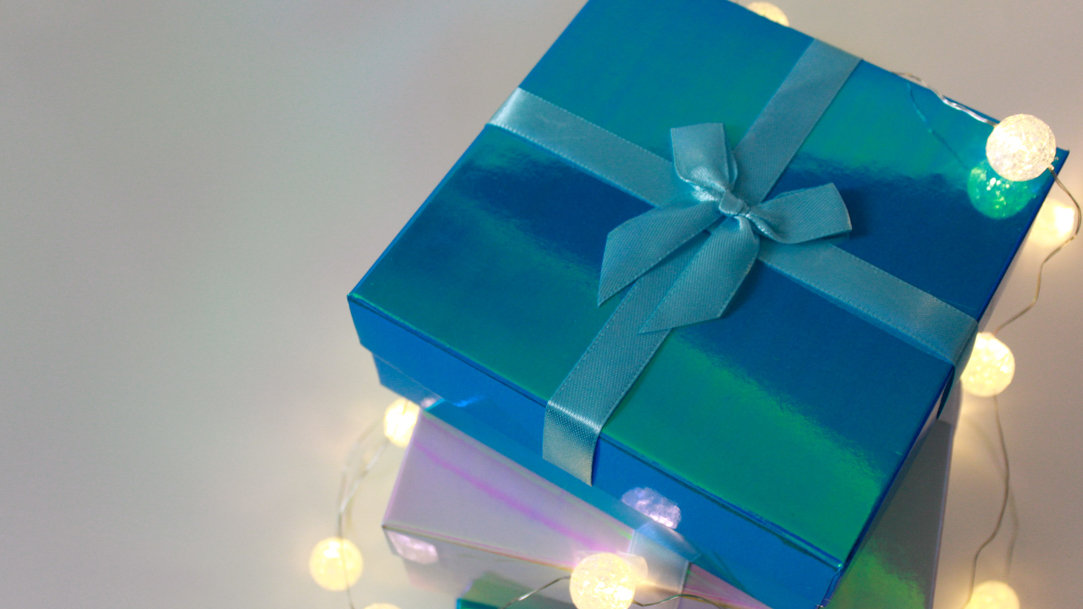 Surface laptop on table surrounded by Christmas decorations