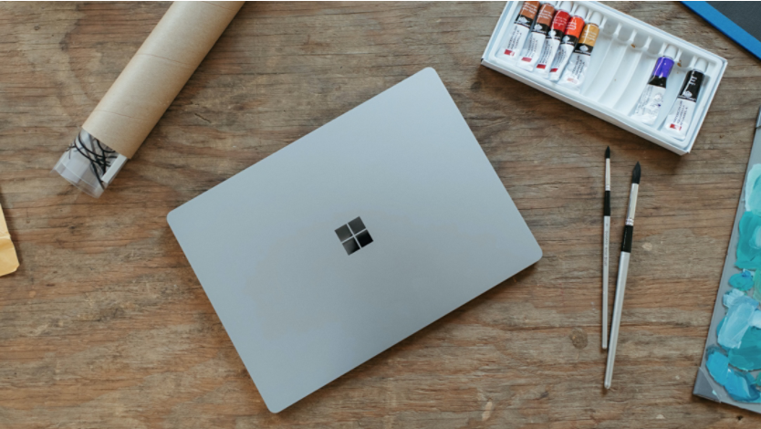 Surface laptop pictured with painting supplies