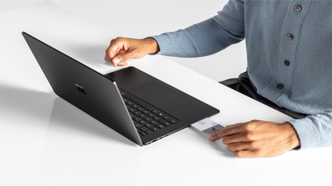 A person using a Smart card reader on the Surface Laptop