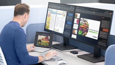 Mies istuu työpöydän ääressä käyttäen Surface Laptopia