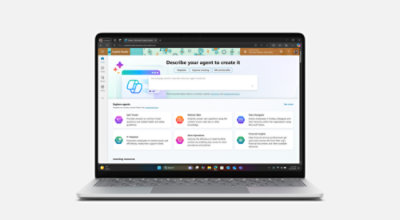 رجل يجلس على مكتبه ويستخدم جهاز Surface Laptop