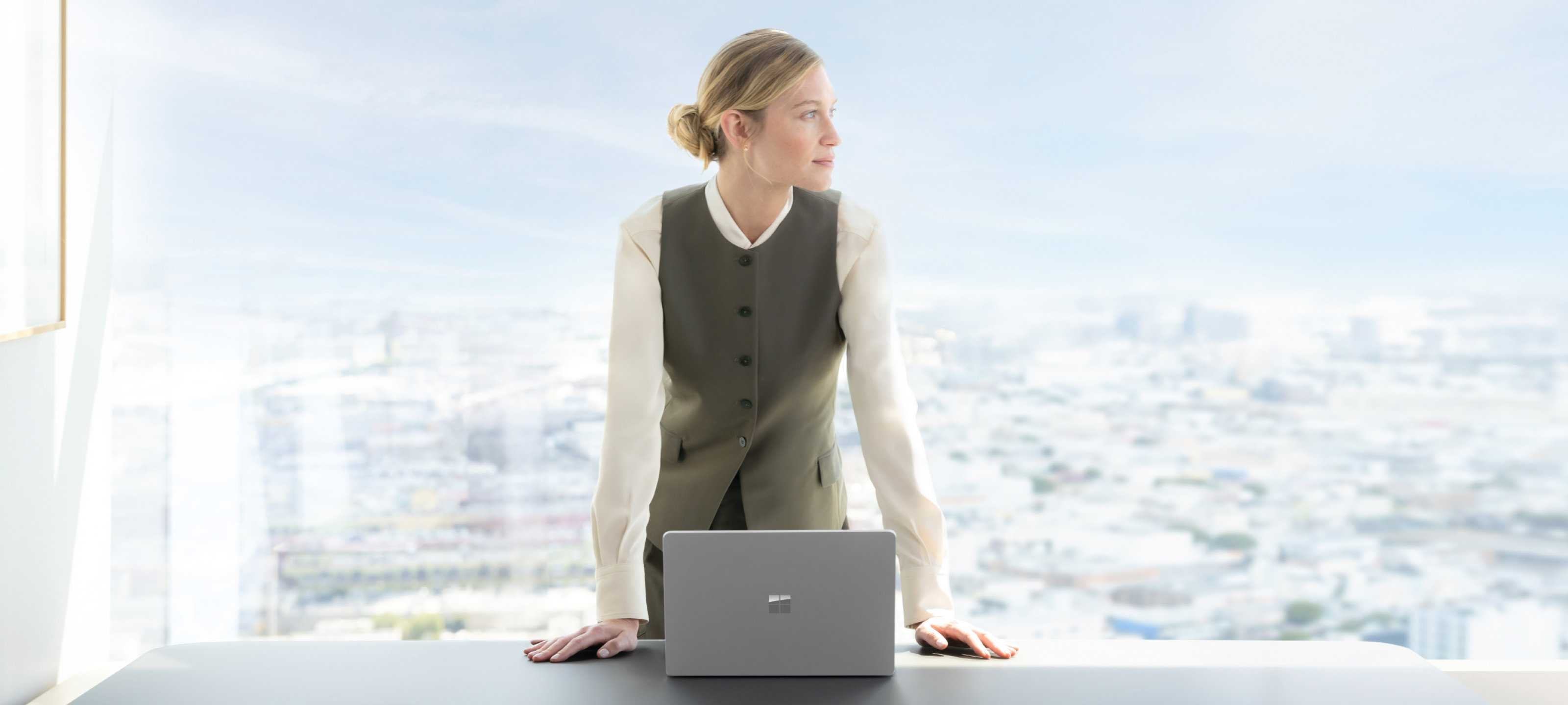 Woman standing in her office with a Surface Laptop