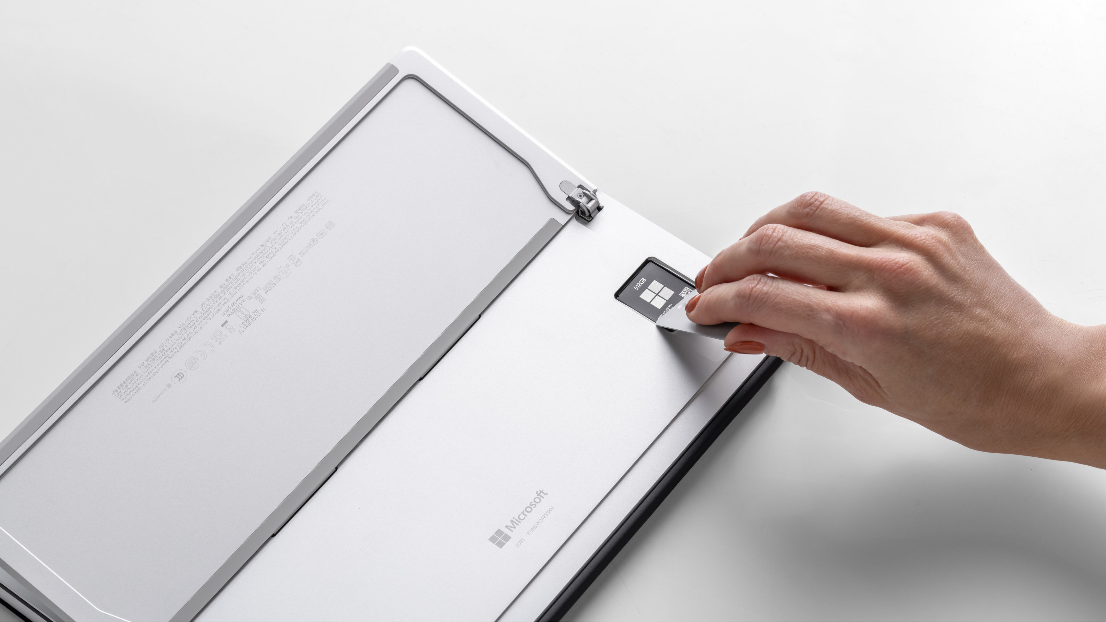 A person removing the SSD from Surface Pro