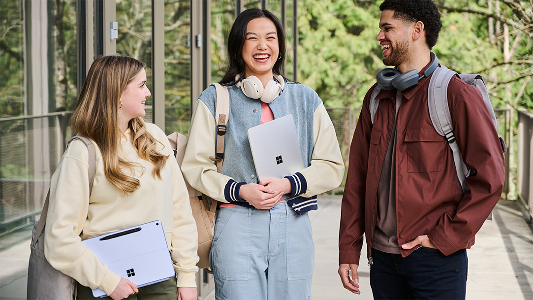 Three students on a college campus with Copilot+ PCs
