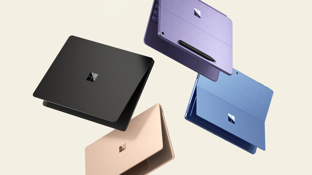 Two Surface Laptops and two Surface Pro 2-in-1 PCs hovering in the air