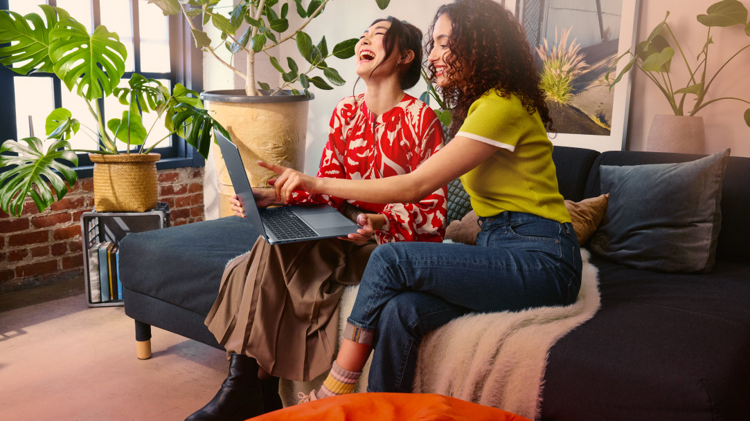 Two adults exploring features on a Copilot+ PC