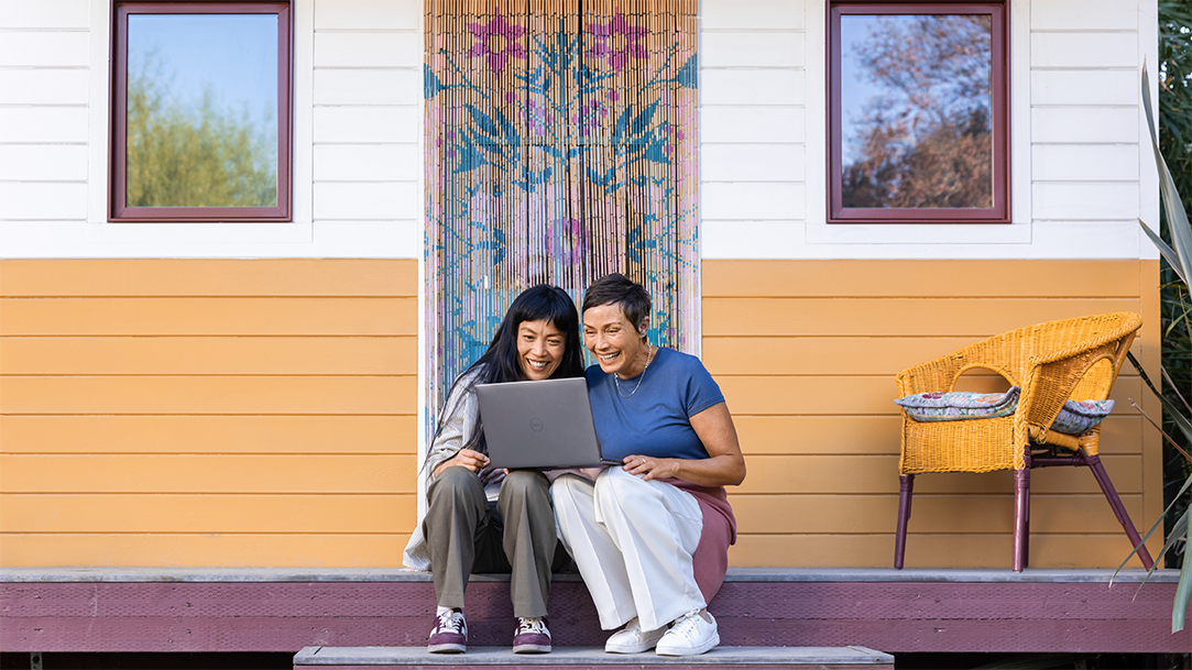 Two females on a porch looking at the best laptop computer for home use