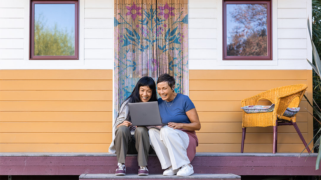 Two females on a porch looking at the best laptop computer for home use