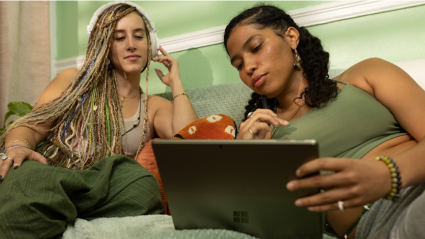 Two girls browse online using a Microsoft Surface