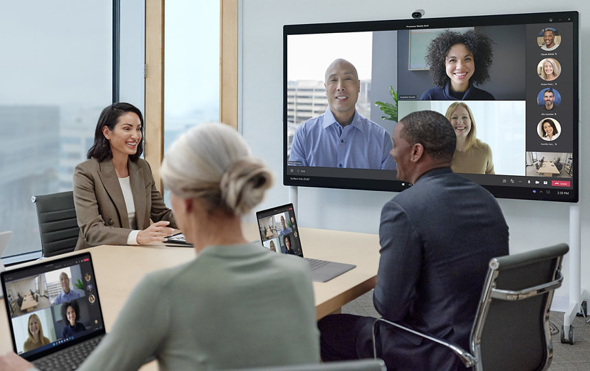 Two groups interact in a Teams call, one team is virtual, while another team is in person.