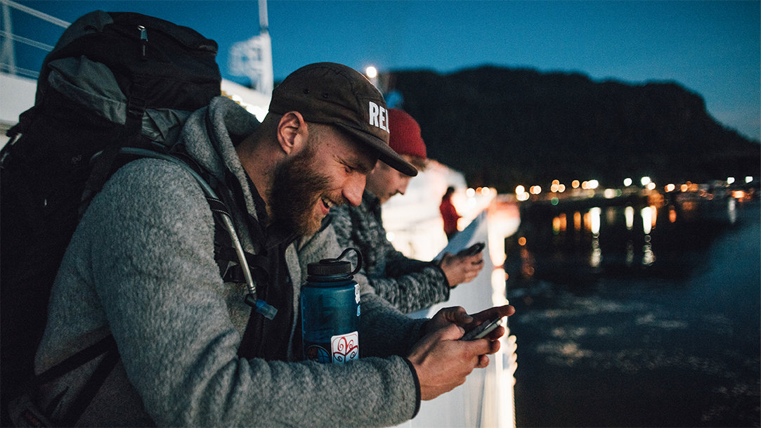 Two men on a boat smiling while using AI for WhatsApp