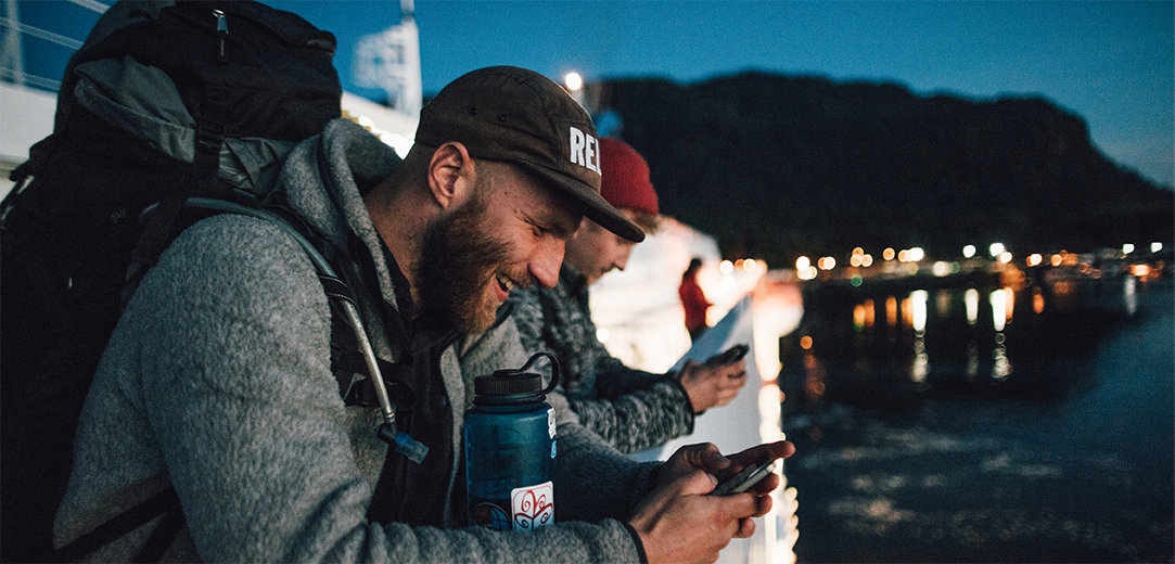 Two men on a boat smiling while using AI for WhatsApp