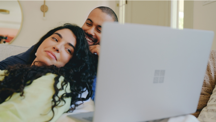 Two people looking at Surface device