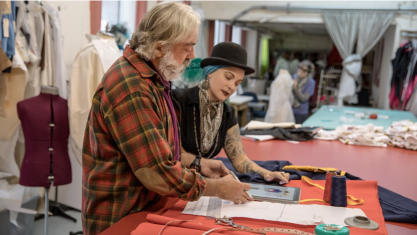 Two people using a Surface to assist with a clothing design