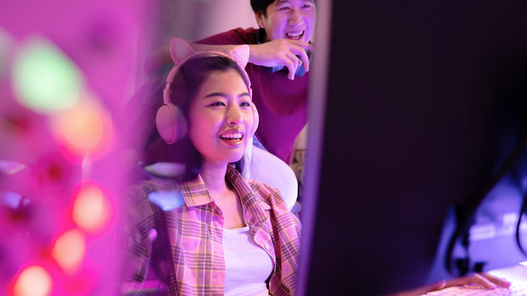 A girl gamer laughing and playing video games