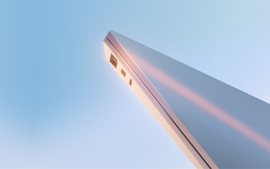 Edge of a chrome Windows 11 Pro PC against a pale blue sky