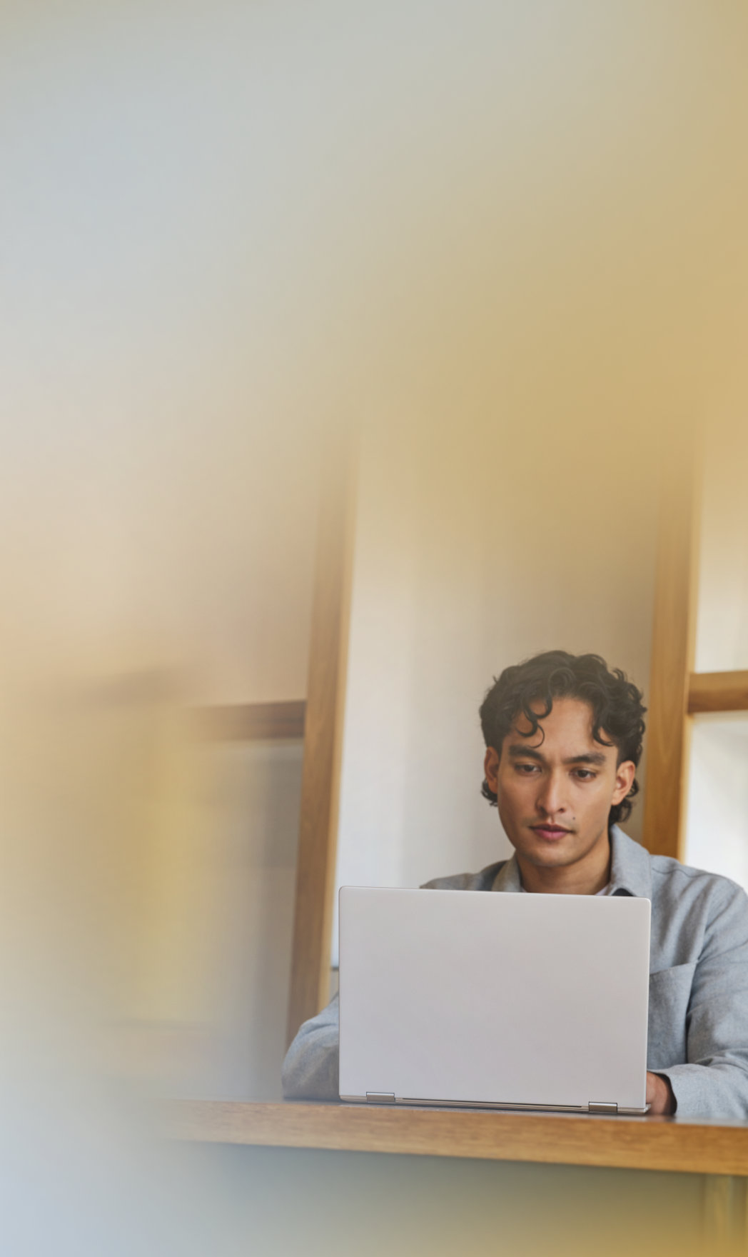 A person in an office working on an open laptop