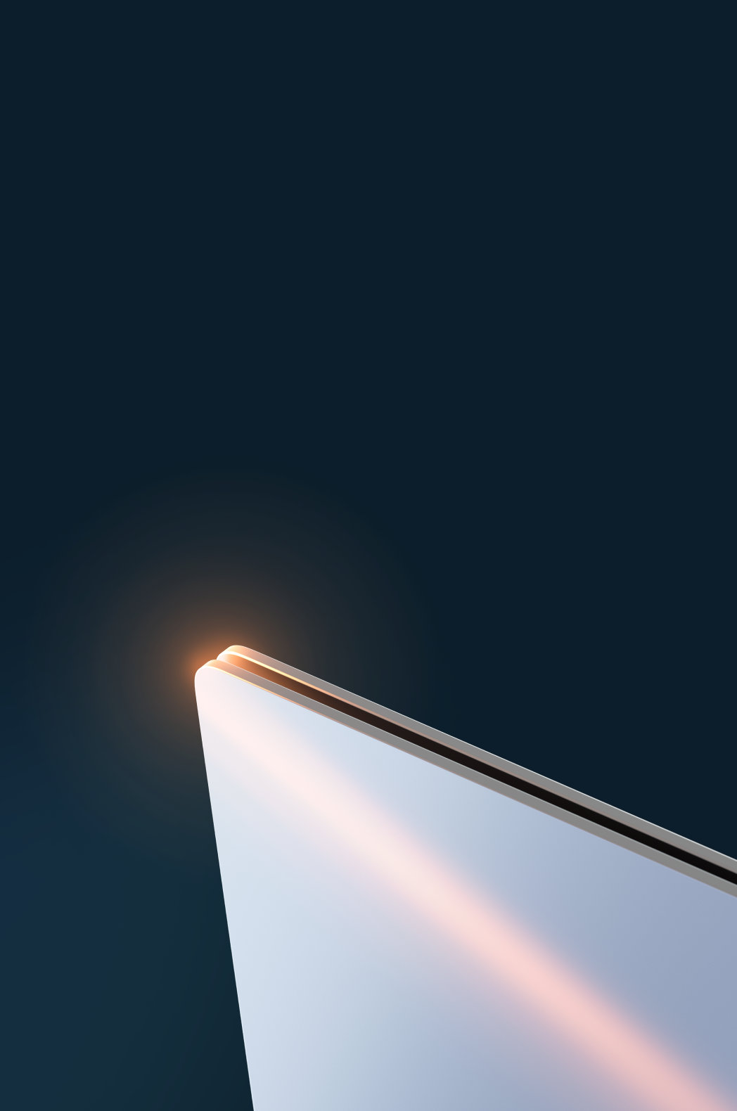 Edge of a closed chrome device tipped on its side against a dark blue background 