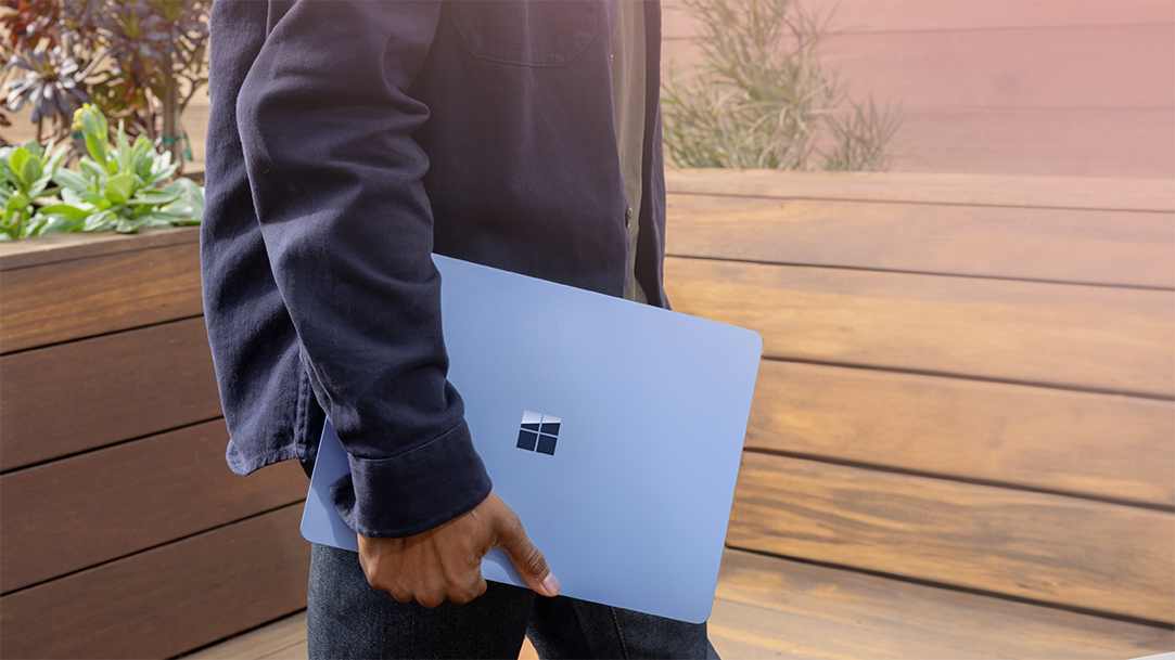 Windows 11 user carrying a new PC