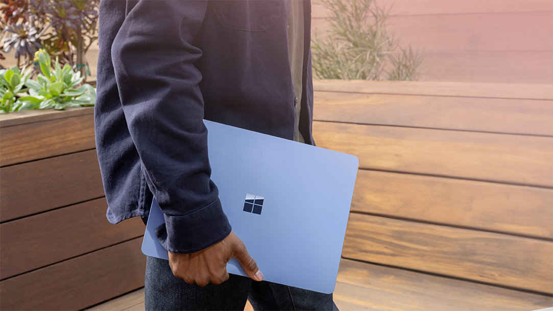 Windows 11 user carrying a new PC