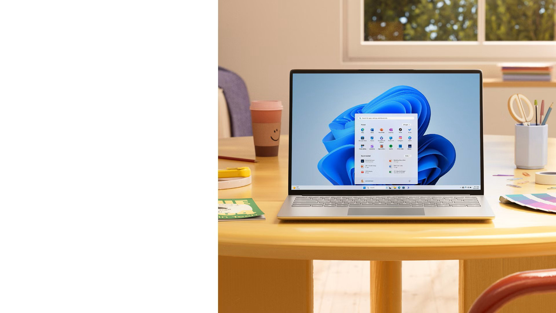 Windows 11 PC with Start menu sitting on a table