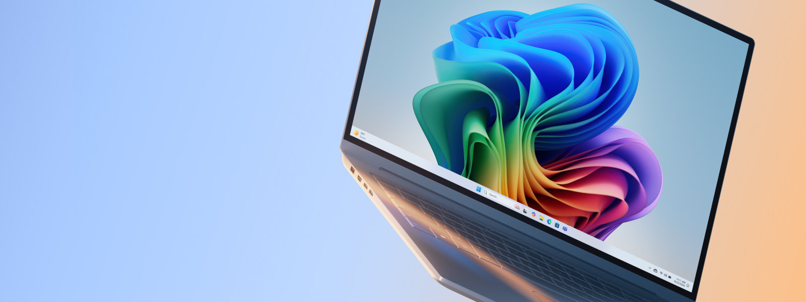 Windows PC with rainbow bloom on a blue and orange gradient background