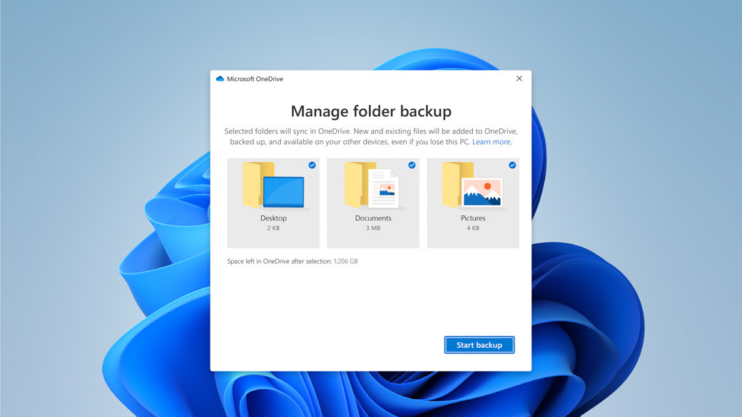 Windows cvet u pozadini sa Microsoft OneDrive dijalogom za upravljanje rezervnom kopijom fascikle