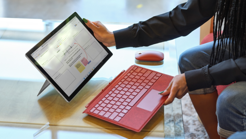 Woman adding Surface Pro Signature Keyboard to her device
