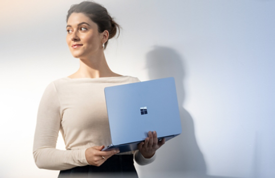 Woman holding Surface Laptop 7ᵗʰ Edition
