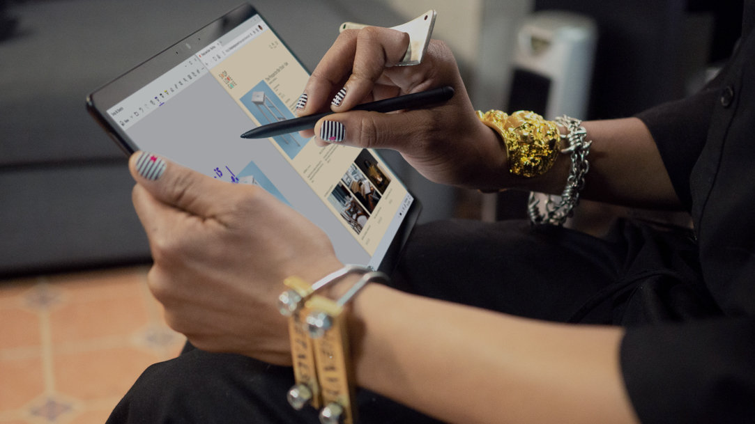 Woman in black shirt using stylus on touchscreen