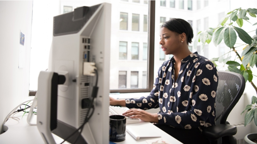 Woman sitting at desk using computer