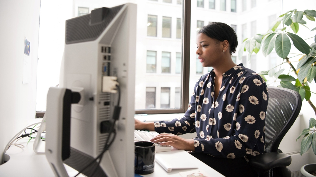 Woman sitting at desk using computer