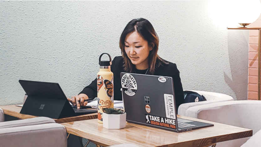 Woman studying at desk with laptop