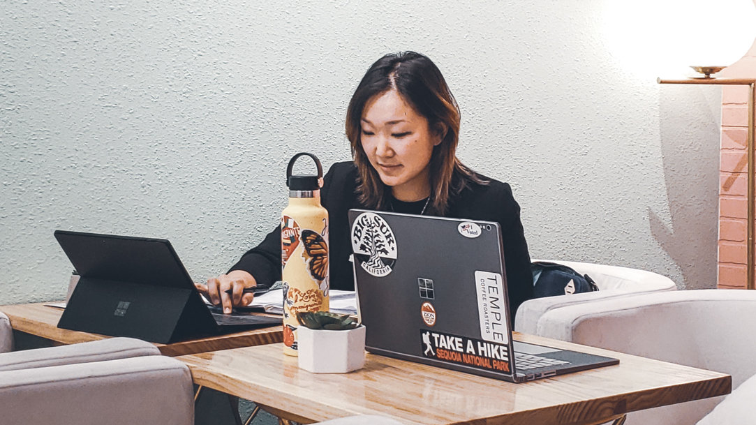 Woman studying at desk with laptop