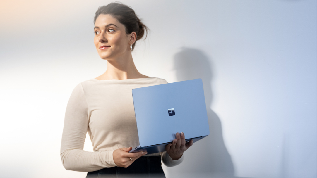Woman using Surface Laptop 7