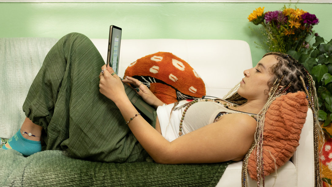 Woman using Surface device on couch