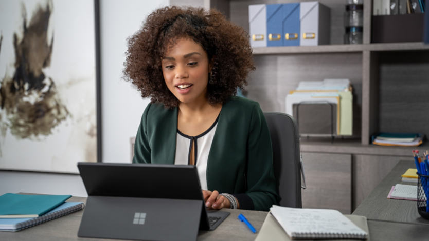 Woman using a Surface laptop on her work desk
