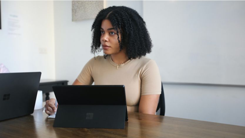 Woman using Surface laptop at table 