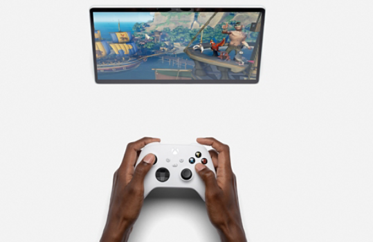 Xbox controller on a table in front of Surface tablet