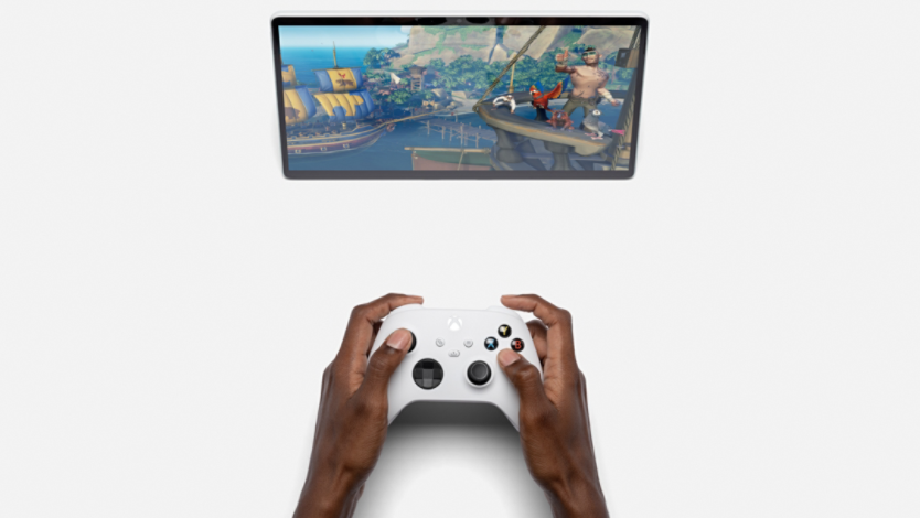 Xbox controller on a table in front of Surface tablet