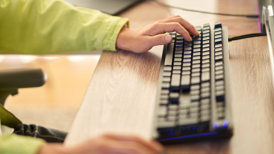 Young adult male typing on keyboard