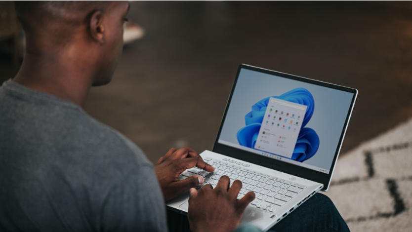 Young man completes work on a Surface 2-in-1 laptop