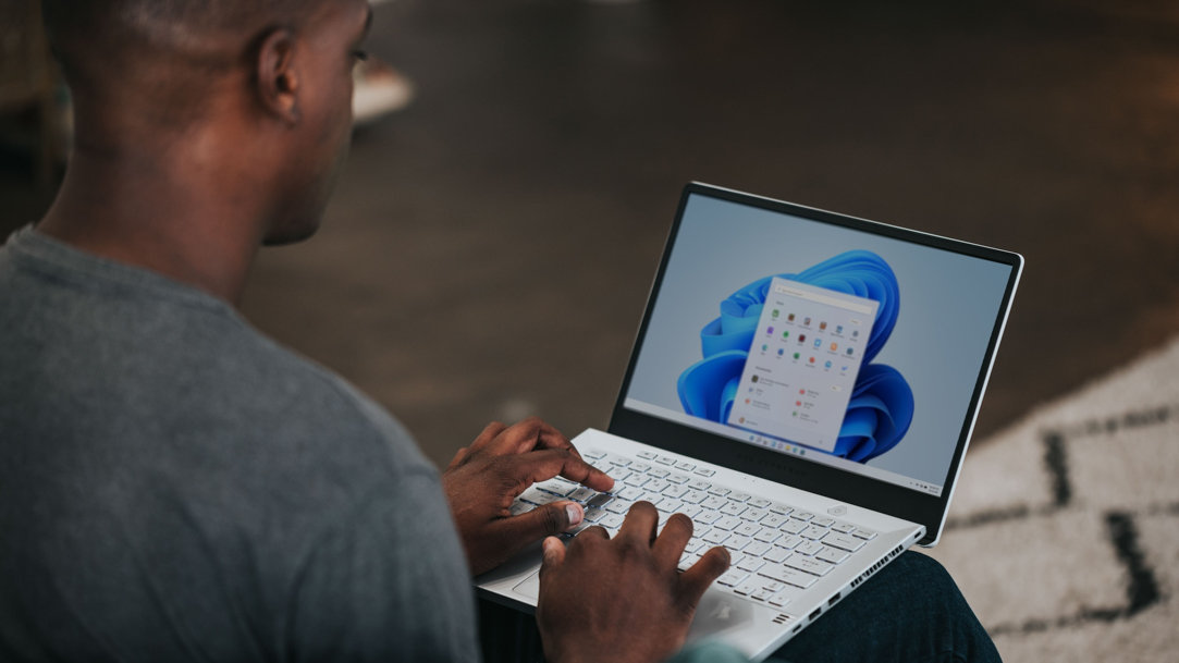 Young man completes work on a Surface 2-in-1 laptop