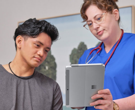 Zdravotní sestra sepisuje příjem pacienta pomocí zařízení Surface Pro v lékařském prostředí