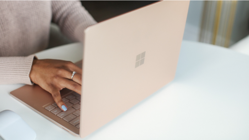 A person using a Microsoft Surface Laptop