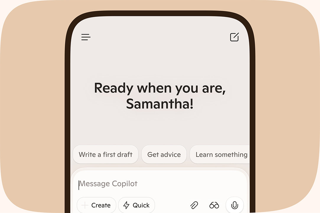 Copilot app on a mobile phone with text saying “Ready when you are, Samantha!” on a light orange background.