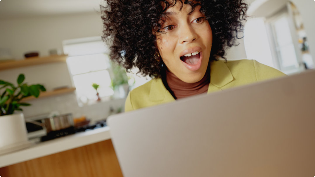 Woman with a surprised look on her face looking at her laptop