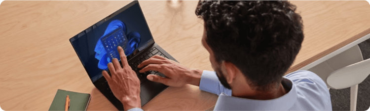 A man using the touchscreen on his computer