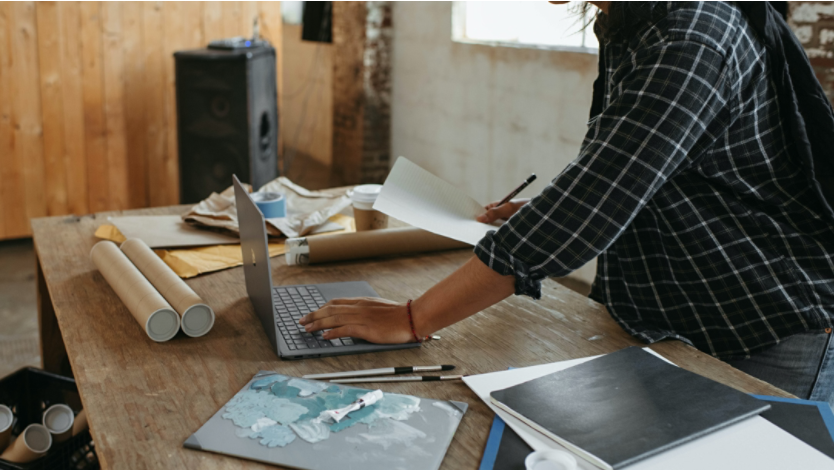 person using a Surface laptop to work on an art project